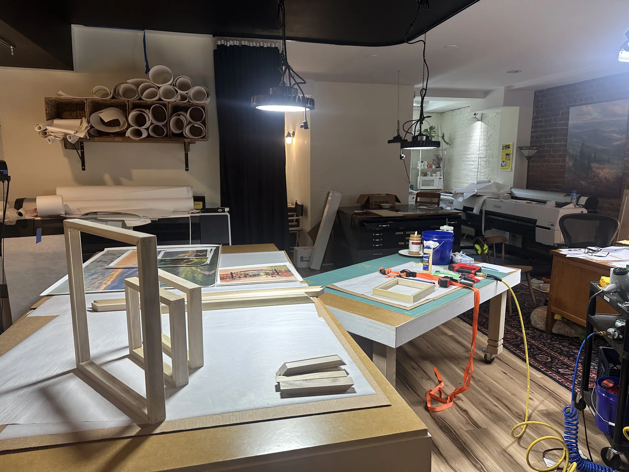 Inside Smoky Mountain Studios workshop with printers, frames, and pieces in progress